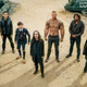 Left to right: Aidan Gallagher, Emmy Raver-Lampman, Robert Sheehan, Tom Hopper, David Castañeda, and Ellen Page star in The Umbrella Academy
